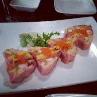 Pink Lady Roll · White fish, salmon, tobiko, avocado, wrapped with pink seaweed in a heart shape. 