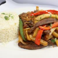 Lomo Saltado de res · Comes with white home made rice and vegetable with french fries.