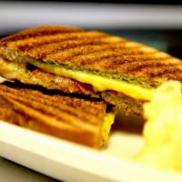 Grilled Cheese Panini with Pesto and Tomato · Vegan provolone and cheddar cheese, fresh pesto and sliced tomato on grilled wheat bread. Se...