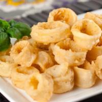 Fried Calamari · Golden and crisp calamari (tubes only, no tentacles) served with a side of tomato sauce and ...