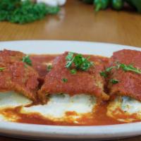 Eggplant Rollatini · Ricotta and mozzarella rolled with golden breaded and fried eggplant, topped with our magnif...