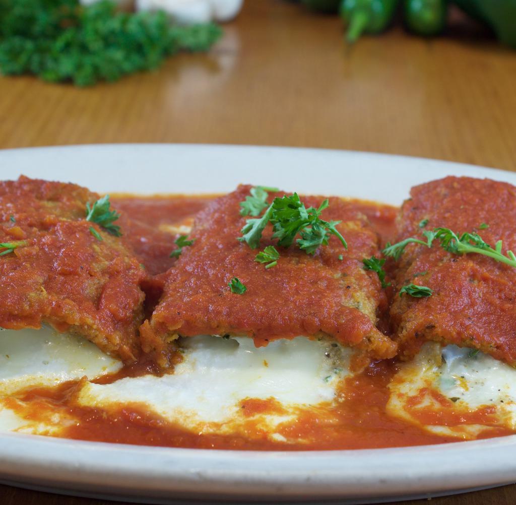 Eggplant Rollatini · Ricotta and mozzarella rolled with golden breaded and fried eggplant, topped with our magnificent tomato sauce.