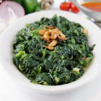 Spinach Sauteed · A healthy portion of spinach sautéed in garlic and oil. Served with a side of bread.