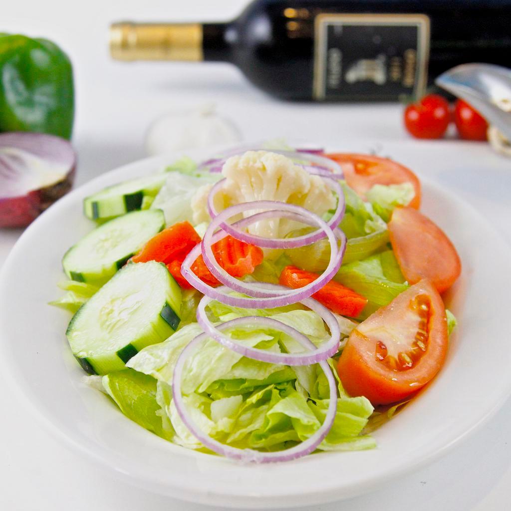 House Salad · Iceberg lettuce, tomatoes, cucumbers, julienned red onions, green olives and giardiniera (Italian pickled vegetables). Dressing served on the side.
