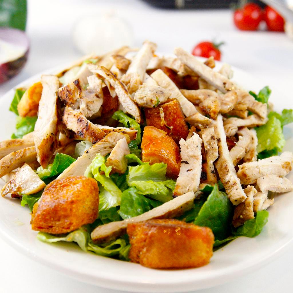Grilled Chicken Caesar Salad · Grilled chicken served over romaine lettuce, croutons and caesar dressing. Dressing is served on the side.