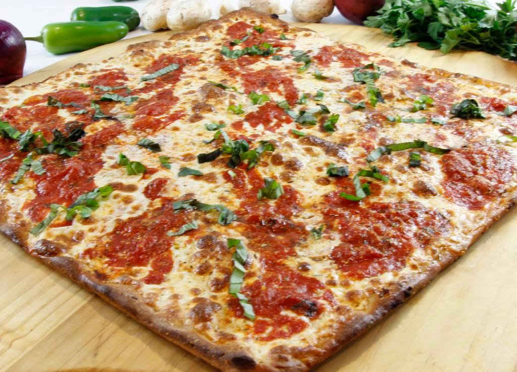 Grandma Pizza Slice · Pizza comes with fresh mozzarella, marinara sauce, fresh garlic and basil chiffonade. It's a very thin pizza and it only comes in one size and shape: 16