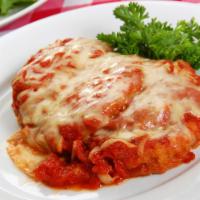Chicken Parmigiana · Breaded and fried chicken cutlets then oven baked with tomato sauce and mozzarella. Served w...