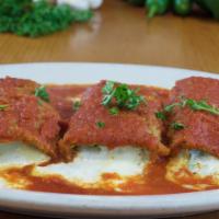 Eggplant Rollatini · Breaded and fried eggplant rolled up with ricotta ana mozzarella, then baked with tomato sau...