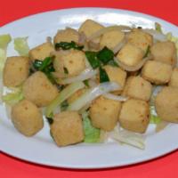 AC7. Salty Crispy Tofu · Fried cubes of tofu tossed with white onions.
