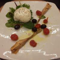 Burrata · With extra virgin olive oil, fresh ground peppers, roasted grape tomatoes and black olives