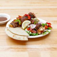 Lamb Kebabs Plate · Two herb grilled lamb skewers served with tossed salad, rice, pita, and homemade yogurt sauce.