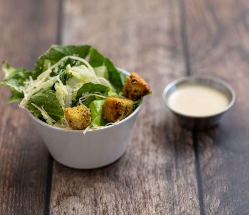 Caesar Salad · Romaine lettuce tossed with Caesar dressing, croutons and Parmesan cheese.