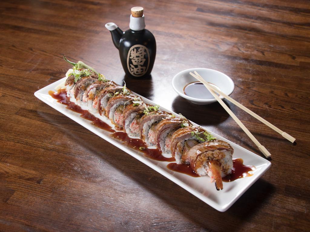 Moo Roll · Shrimp tempura, Kanikama salad, topped with seared rib eye steak, scallions and kabayaki sauce.