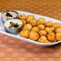 Punugulu · Fried snack made with rice, lentil and spices served with three chetneys.