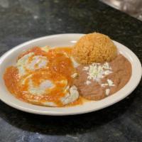 Huevos Rancheros · 2 eggs over easy on a flat tortilla with ranchero sauce.