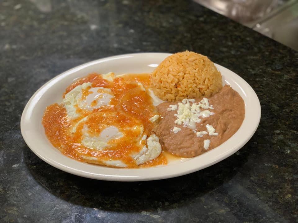 Huevos Rancheros · 2 eggs over easy on a flat tortilla with ranchero sauce.