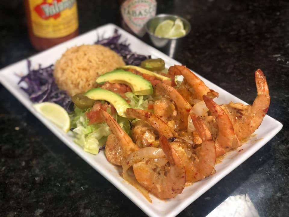 Camarones Miguelon  · 8 pieces. Butterfly cut shell on shrimp sauteed in special spicy sauce and side of rice. Spicy.