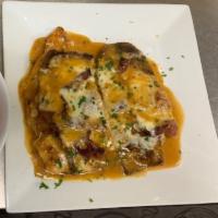 Chicken Sorrentino · Flour battered chicken cutlet topped with sliced prosciutto, sliced eggplant and mozzarella ...