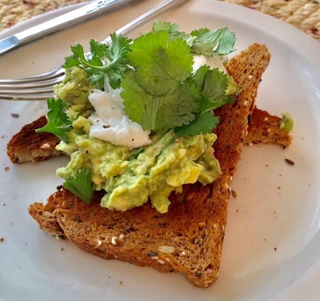 Avocado Toast · Avocado mashed with lemon juice, olive oil, salt, pepper. Served on toast. Topped with small dollop of sour cream and a bit of chili flake. Comes with kettle chips, lettuce, tomato, red onion, house pickles on the side.