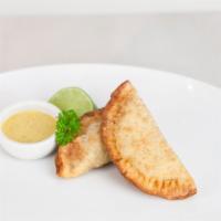 Chicken empanadas · Two crispy pastries filled with: Shredded rotisserie chicken, carrots, parsley in a creamy A...