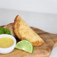 Veggie empanadas · Two crispy pastries filled with: Roasted mushroom, spinach, choclo, oaxaca cheese.