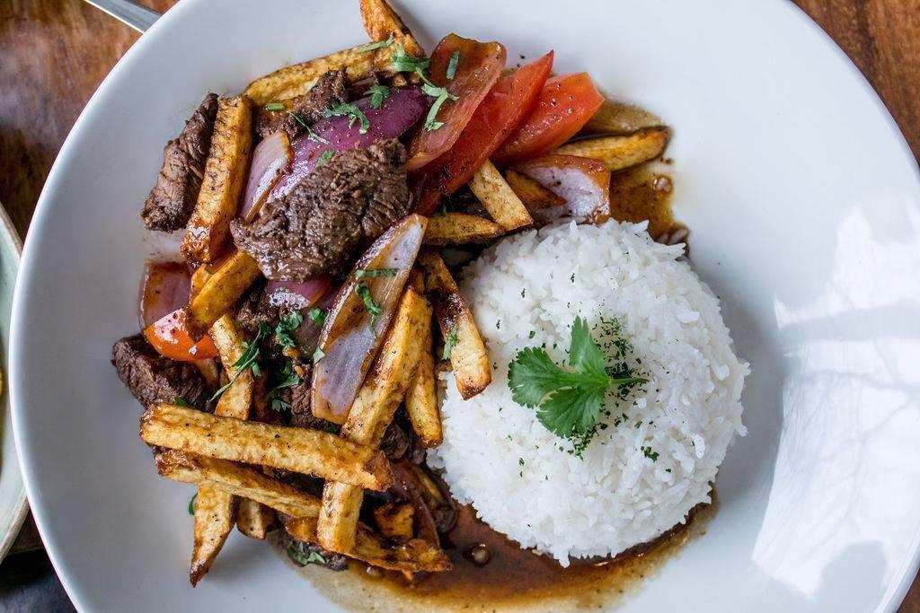 Lomo saltado · Traditional Peruvian favorite! Wok stir-fried beef tenderloin with onions, tomatoes in ginger-infused soy sauce, french fries & served with jasmine rice.
*Contains gluten, shellfish (oyster sauce) & soy