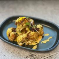 Coliflor picante · Crispy cauliflower tossed in a spicy mayo sauce.