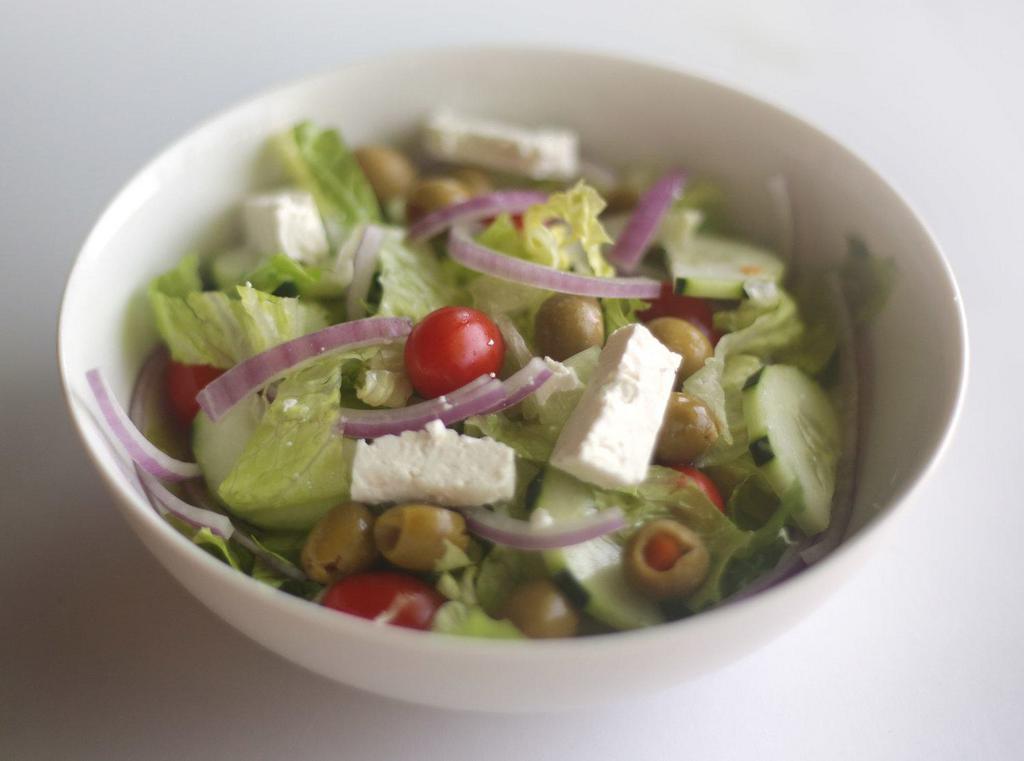 Greek Salad · Romaine, tomatoes, cucumber, olives, feta and red onion in a light lemon dressing.