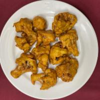 Gobhi Pakora · Cauliflower pieces deep fried with chickpeas flour herbs and spices batter.