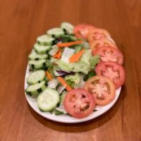 Green Salad · Lettuce, cucumber slices, tomatoes and green bell peppers. 