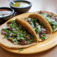 Steak Taco · Soft shell taco. Served with onions and cilantro.