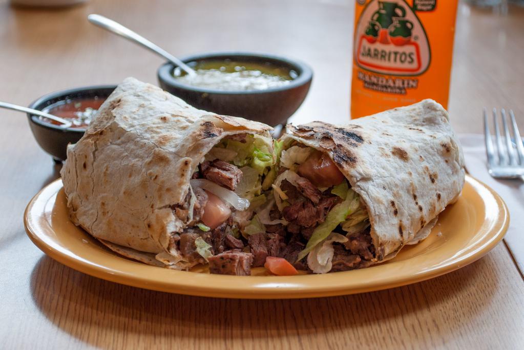 Steak Super Burrito · A large flour tortilla rolled and stuffed with rice, beans, lettuce, tomato, cheese, sour cream and guacamole.