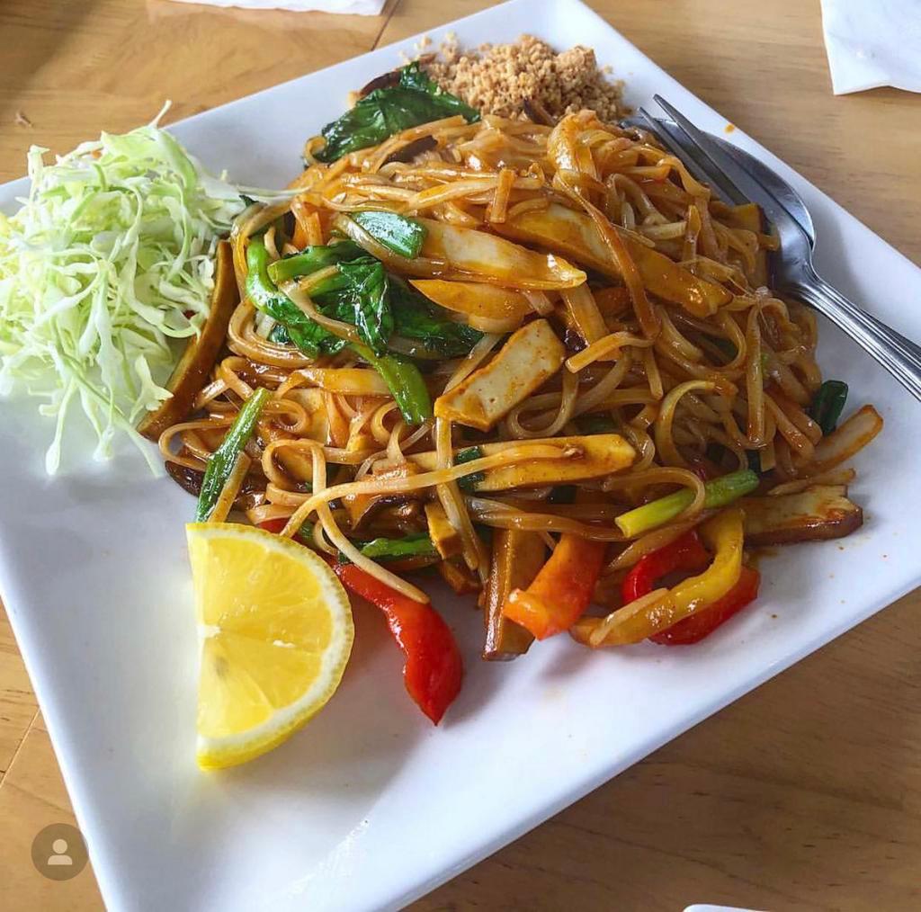 Spicy Noodles · Rice noodles with red bell peppers, mushrooms, bean sprouts, onions, pea shoot and scrambled egg garnished with crushed peanuts, cabbage and lemon wedge.