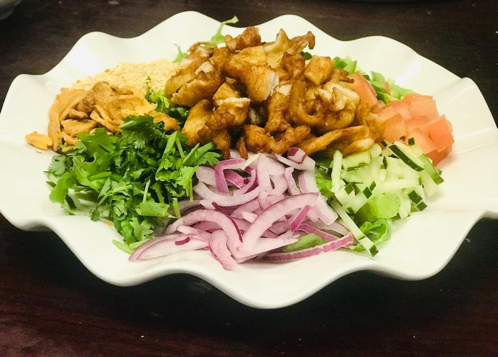 Chicken Salad · Fried bite sized chicken with lettuce, garlic chips, fresh red onions, fried onions, cilantros, cucumber, jalapenos, lemon and house chili sauce.