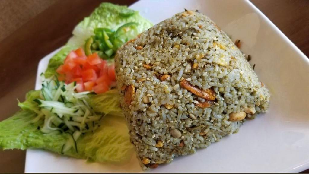 Tea Leaf Rice Salad · Fermented tea leaf paste mixed with jasmine rice, peanuts, sunflower seeds, sesame seeds and garlic chips served with lettuce, tomatoes and cucumbers.