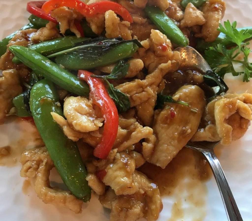 Lemongrass Chicken · Wok stir-fried with lemongrass snap peas, garlic, soy sauce, red bell peppers and finished with basil.