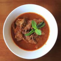 Traditional Red Curry with Chicken · Red curry cooked with garlic, onions, ginger, lemongrass and red chili cooked in traditional...