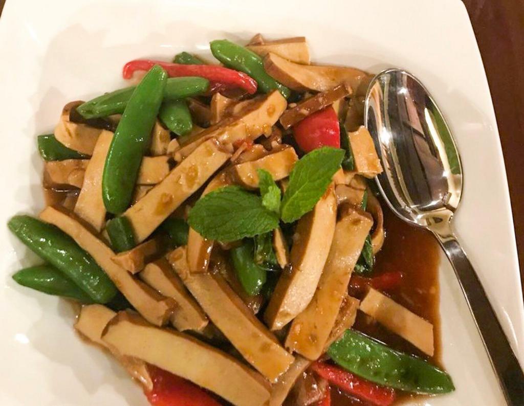 Lemongrass Tofu · Wok stir-fried with lemongrass, snap peas, garlic, soy sauce, red bell peppers and finished with basil.