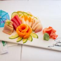 Sashimi Assortment · Fifteen pieces of assorted raw fish. Served with miso soup and garden salad with ginger dres...