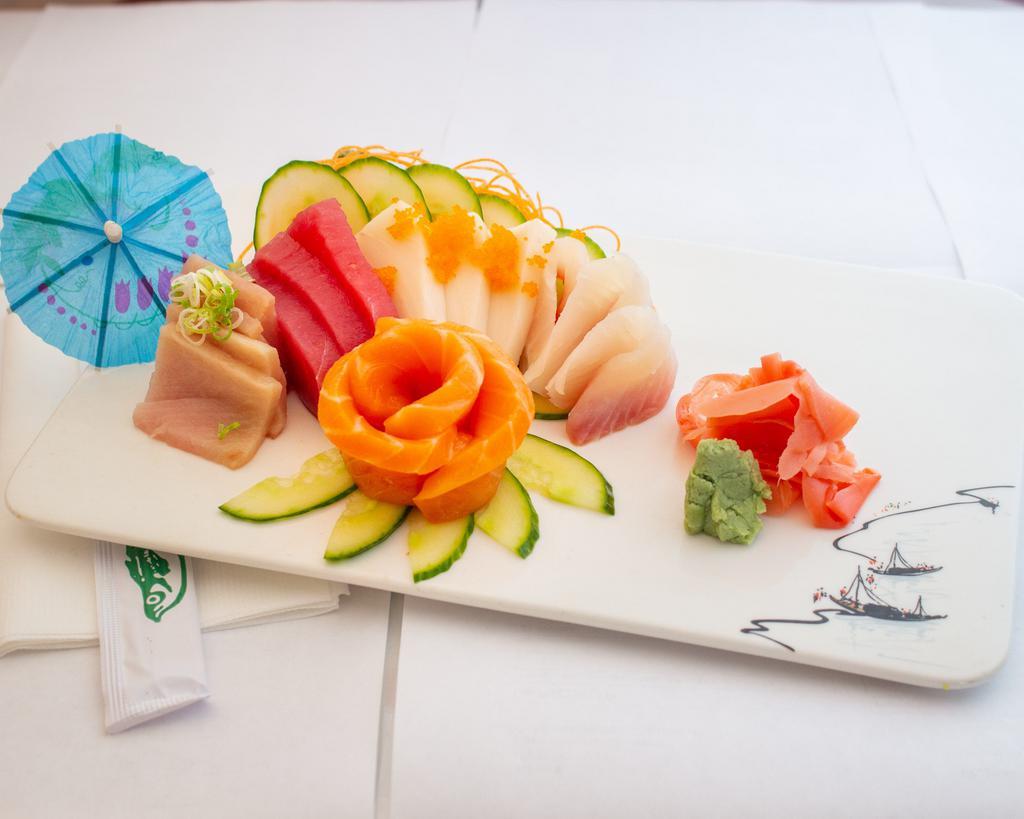 Sashimi Assortment · Fifteen pieces of assorted raw fish. Served with miso soup and garden salad with ginger dressing. 