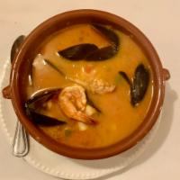Traditional French Fish Stew · Medley of monk fish, cod, shrimp, scallops and mussels in a hearty broth.