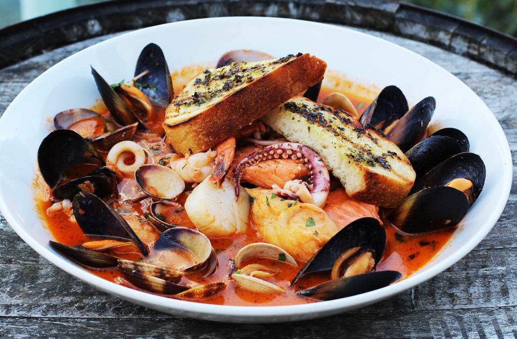 Seafood Cioppino · Salmon, cod, manila clams, mussels, prawns, calamari, grilled sourdough. Add 2 oz. of dungeness crab for an additional charge.