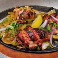Tandoori Chicken · Marinated chicken (with bone) in a yogurt and curry spices,
cooked in tandoor