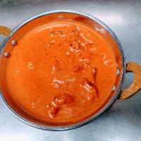 Butter Chicken · Oven-roasted chicken cooked with herbs and spices in a rich
creamy tomato onion sauce