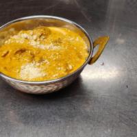 Chicken Korma · Chicken with cashew nuts, shredded coconut and cream
simmered to perfection with herbs and s...