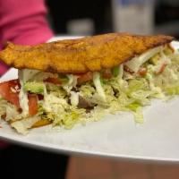 Patacon Amarillo · Our famous plantain sandwich with lettuce, tomato, shredded white cheese, ketchup and mayo.