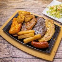 Parrilla Mixta Especial · Grilled chicken, steak, grilled pork and pork sausages. Served with tostones, fried yucca, a...