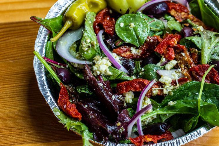 Greek Salad · Spring mix, red onions, sun-dried tomatoes, feta, Kalamata olives, and a pepperoncini pepper with your choice of homemade dressing.
