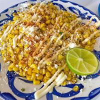 Street Corn (Elotes) · Roasted corn slathered with mayonnaise, Mexican creama , salty cotija cheese and  seasoned w...