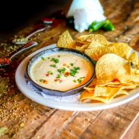 Queso Dip · Tasty and creamy pepper jack cheese dip, flavored with poblano peppers. Served hot with our ...